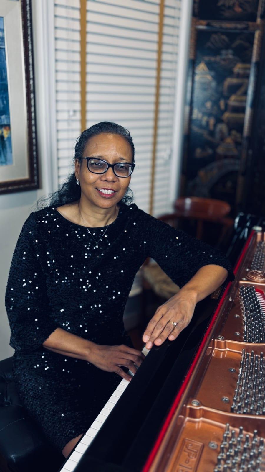 Grace J Reid at the keys of a grand piano